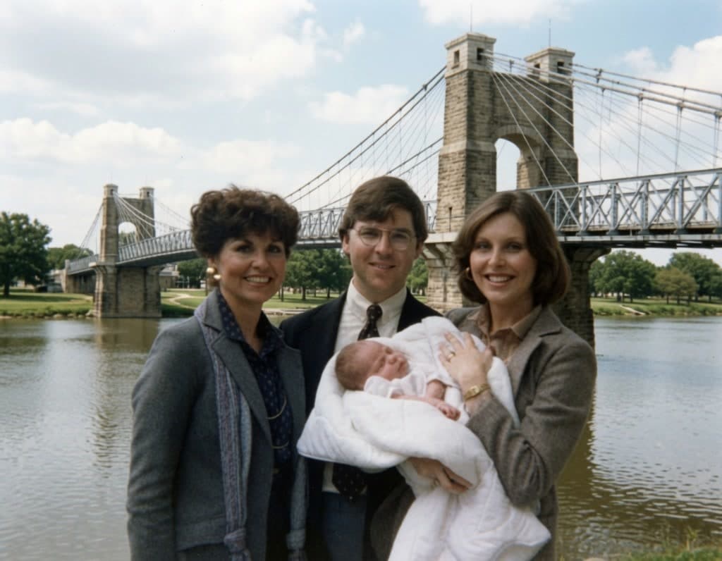 The Swann family in front of a suspension bridge — a vintage portrait from the legacy era