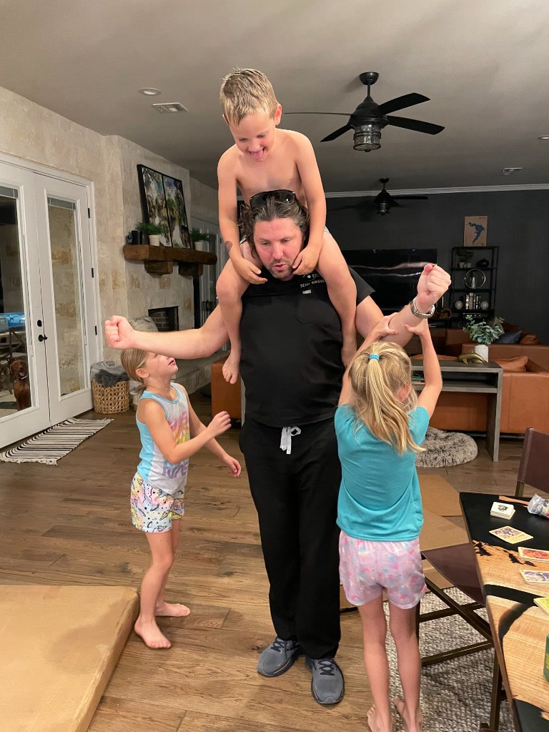 Dr. Beau Swann playing with Brad's children at home — Uncle Beau at his best